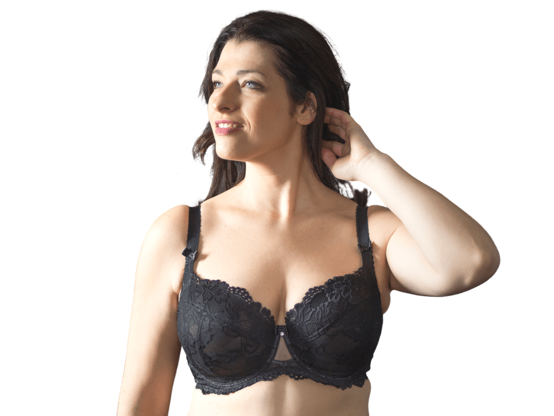 Front view of model wearing black BM Balconette bra while reaching up and grabbing a tassel of her hair